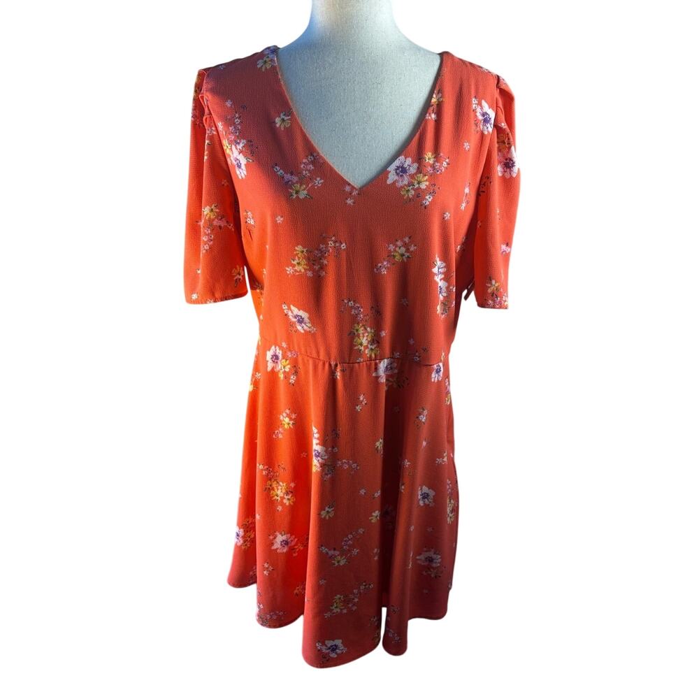 Coral floral mini dress with a flattering V-neck and short sleeves.
